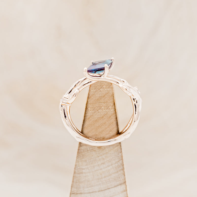 Shown here is "Artemis on the Vine", a branch-style lab-created alexandrite women's engagement ring with diamond and leaf accents, side view on stand. Many other center stone options are available upon request.