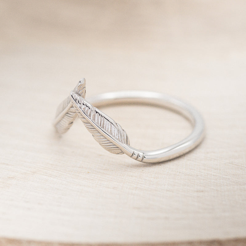 Shown here is "Fala", a feather-style tracer wedding band that is made to go with some of our engagement rings, facing left (email for options).