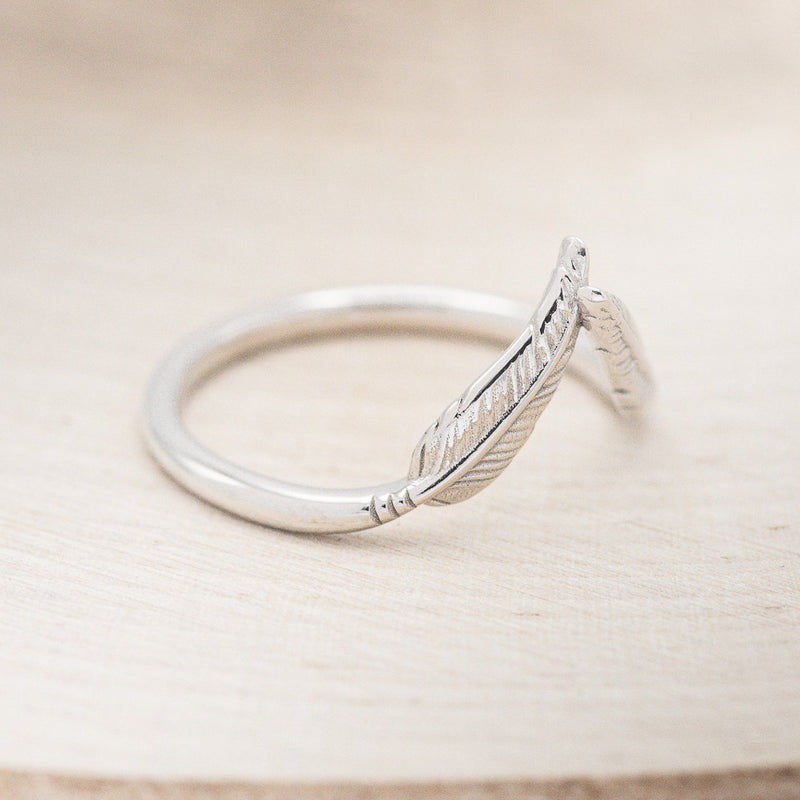 Shown here is "Fala", a feather-style tracer wedding band that is made to go with some of our engagement rings, facing right (email for options).