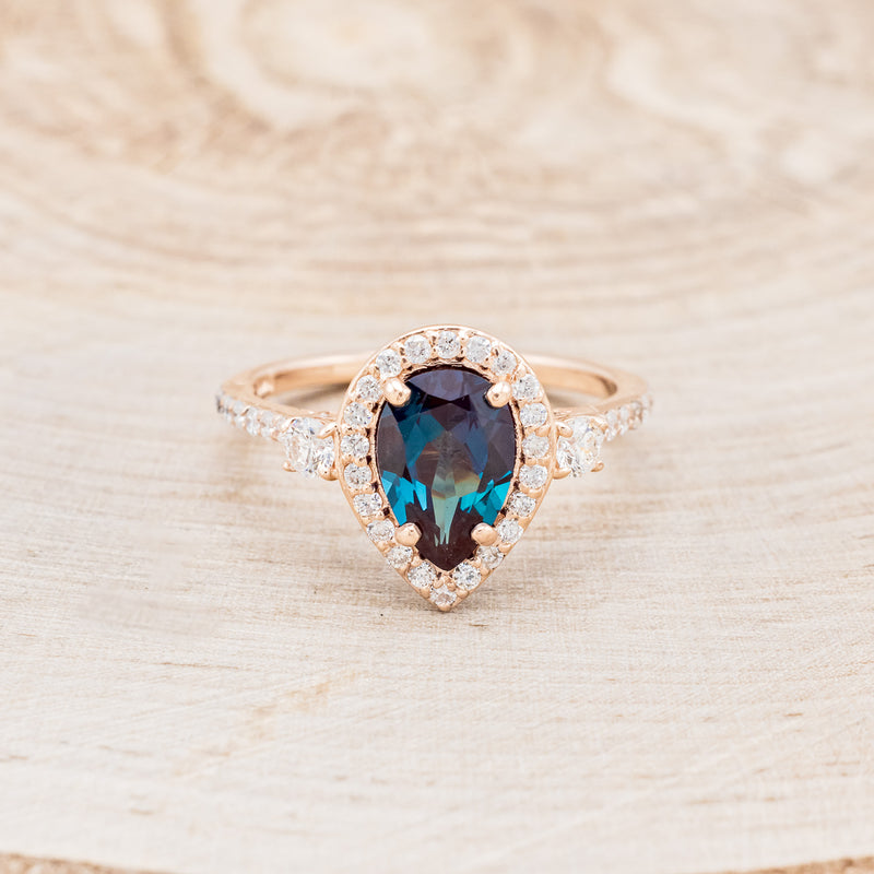 Shown here is "KB", a lab-created alexandrite women's engagement ring with diamond halo & accents, front facing. Many other center stone options are available upon request.