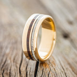 Shown here is "Cosmo", a custom, handcrafted men's wedding ring featuring ironwood and antler inlays, upright facing left. Additional inlay options are available upon request.