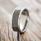 Shown here is "Rainier", a handcrafted men's wedding ring featuring an iron ore inlay, upright facing left. 