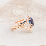 Shown here is "Clariss", a bridal suite-style lab-created alexandrite women's engagement ring with a diamond halo, "Fala" tracer, and "Sama" tracer, facing right. Many other center stone options are available upon request.