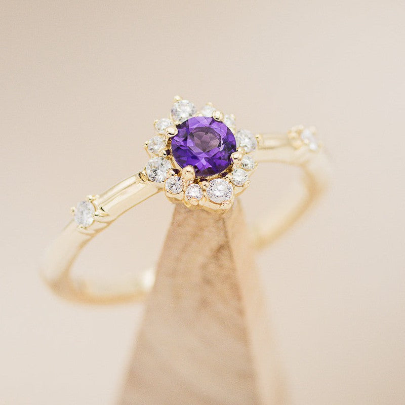 Shown here is The "Starla", a halo-style round Amethyst women's engagement ring with delicate and ornate details and is available with many center stone options