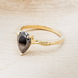 "HOPE" - PEAR-SHAPED MIDNIGHT BLACK MOISSANITE SOLITAIRE ENGAGEMENT RING WITH FEATHER ACCENTS
