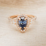 "KB" - PEAR-SHAPED ICY BLUE MOISSANITE ENGAGEMENT RING WITH DIAMOND HALO & ACCENTS