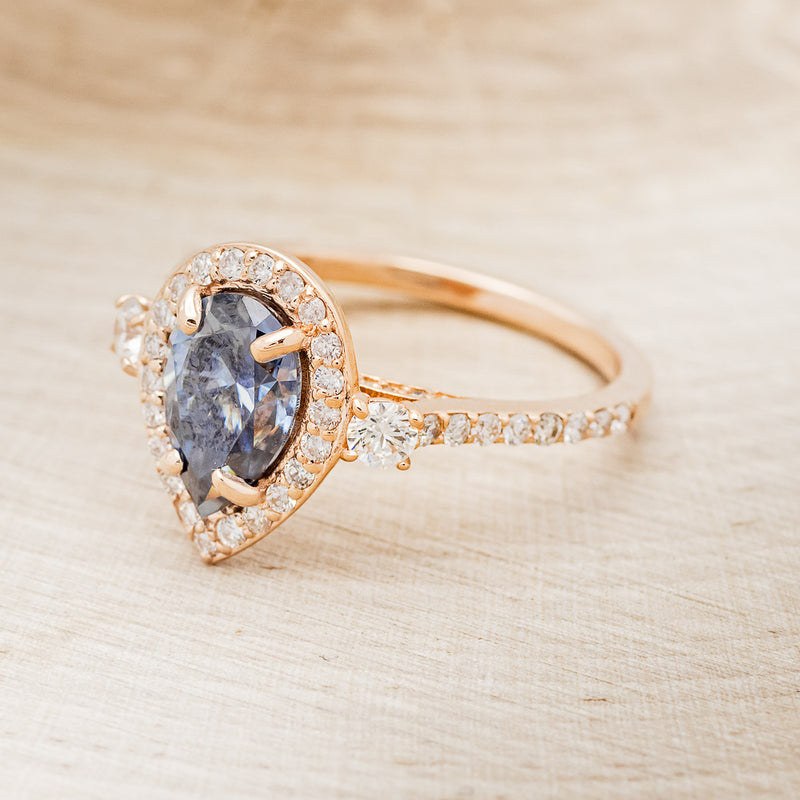 "KB" - PEAR-SHAPED ICY BLUE MOISSANITE ENGAGEMENT RING WITH DIAMOND HALO & ACCENTS