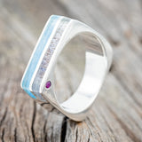 Shown here is "Vega", a custom-shaped wedding band, featuring elk antler & turquoise inlays with two offset rubies, upright facing left. Additional inlay options are available upon request.