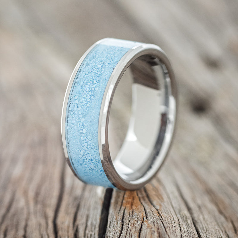 Shown here is "Rainier", a custom, handcrafted men's wedding ring featuring a crushed turquoise inlay, upright facing left. Additional inlay options are available upon request.