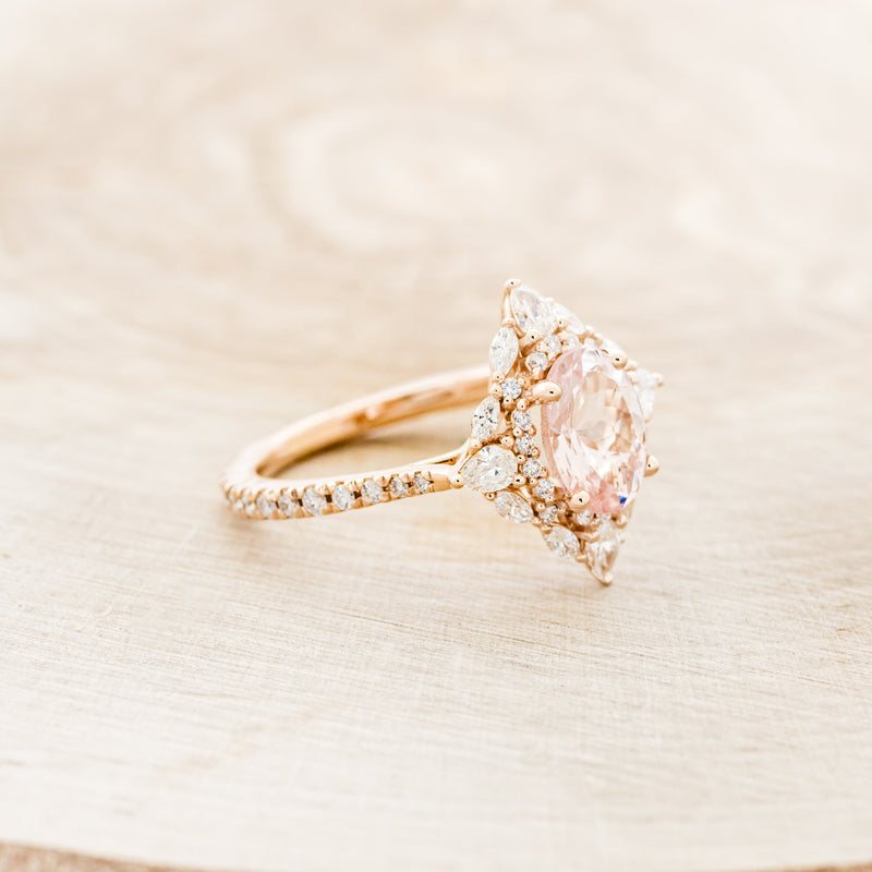 Shown here is "North Star", an oval morganite women's engagement ring with a diamond halo and diamond accents, facing right. Many other center stone options are available upon request.