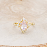 Shown here is "North Star", an oval morganite women's engagement ring with a diamond halo and diamond accents, front facing. Many other center stone options are available upon request.