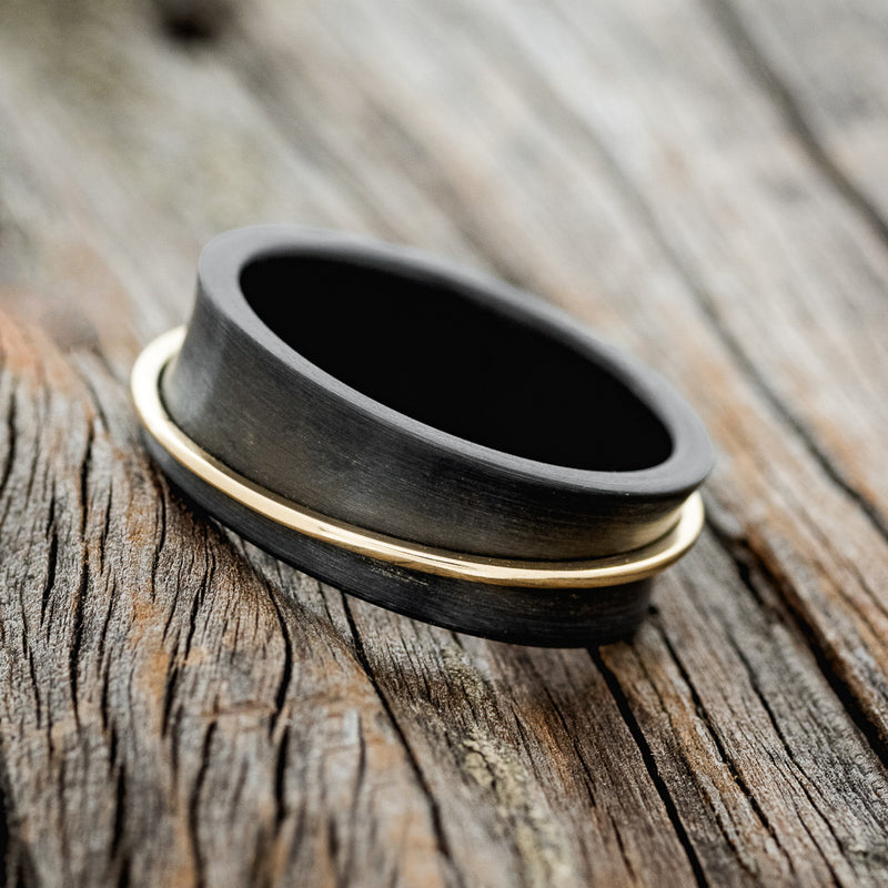 "ROTARY" - 14K GOLD SPINNER WEDDING RING FEATURING A CONCAVE BLACK ZIRCONIUM BAND