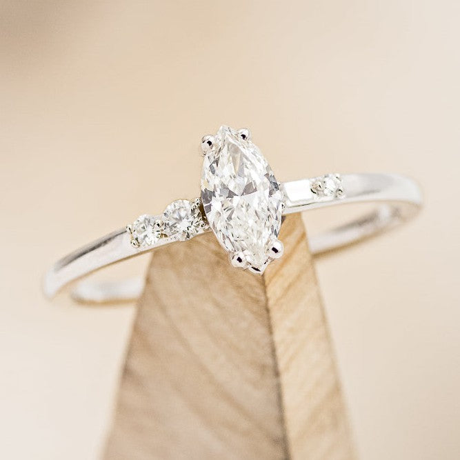 Shown here is The "Julie", an accented marquise moissanite women's engagement ring with delicate and ornate details and is available with many center stone options