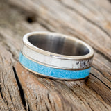 Shown here is "Dyad", a custom, handcrafted men's wedding ring featuring 2 channels with turquoise and antler inlays, tilted left. Additional inlay options are available upon request.