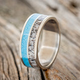 Shown here is "Dyad", a custom, handcrafted men's wedding ring featuring 2 channels with turquoise and antler inlays, upright facing left. Additional inlay options are available upon request.