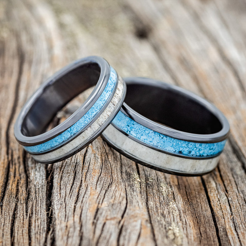 Shown here is "Dyad", a matching set, is a custom, handcrafted matching set of wedding rings featuring elk antler and turquoise inlays, laying together. Additional inlay options are available upon request.