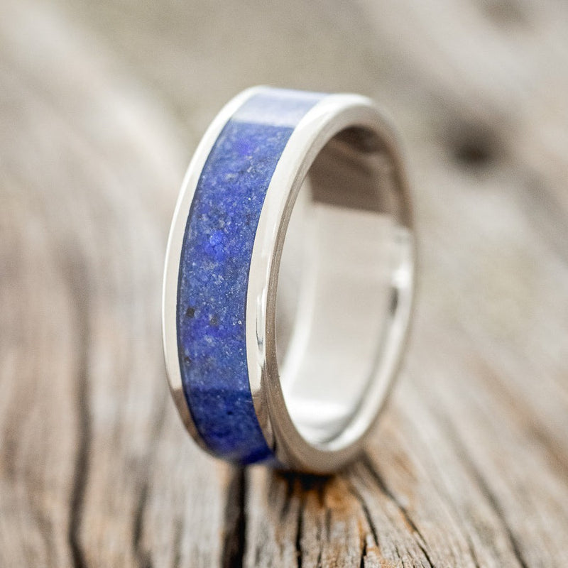 Shown here is "Rainier", a custom, handcrafted men's wedding ring featuring a lapis lazuli inlay, upright facing left. Additional inlay options are available upon request.