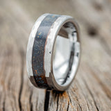 Shown here is a custom, handcrafted men's wedding ring featuring a patina copper inlay with faceted edges tungsten band, upright facing left. Additional inlay options are available upon request