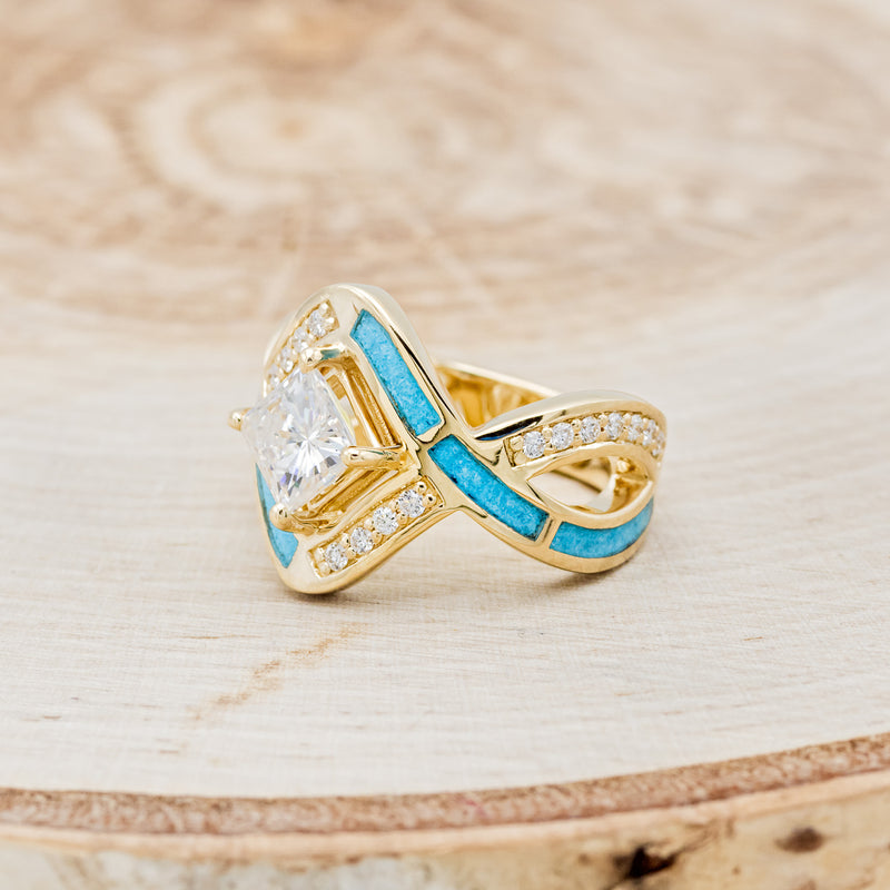 Shown here is "Helix", a geometric-style princess cut moissanite women's engagement ring with diamond accents and turquoise inlays, left facingenter stone options are available upon request
