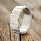 Shown here is "Dallas", a handcrafted men's wedding ring featuring a hand-turned solid metal wedding band with a fluted finish, upright facing left. Additional inlay options are available upon request.