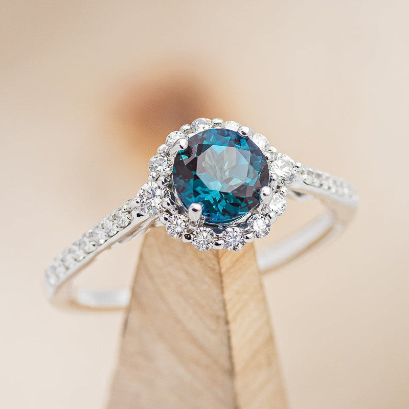 Shown here is the "Ophelia", a lab-created alexandrite women's engagement ring with a diamond halo and diamond accents. Many other center stone options are available upon request.