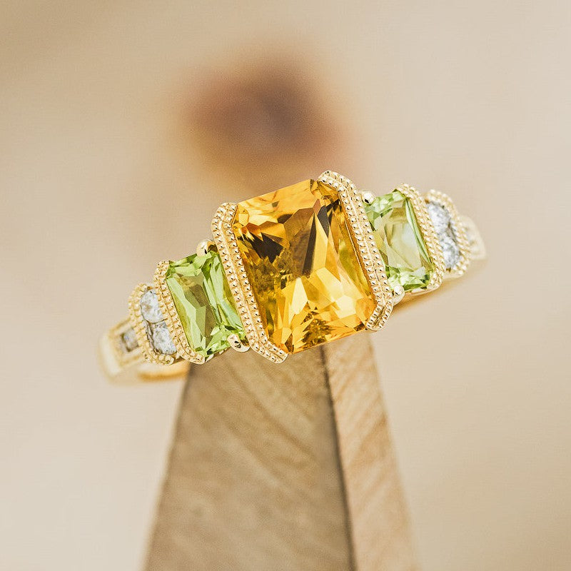 Shown here is "Hazel", a citrine women's engagement ring with peridot and diamond accents, on stand facing slightly right.. Many other center stone options are available upon request.