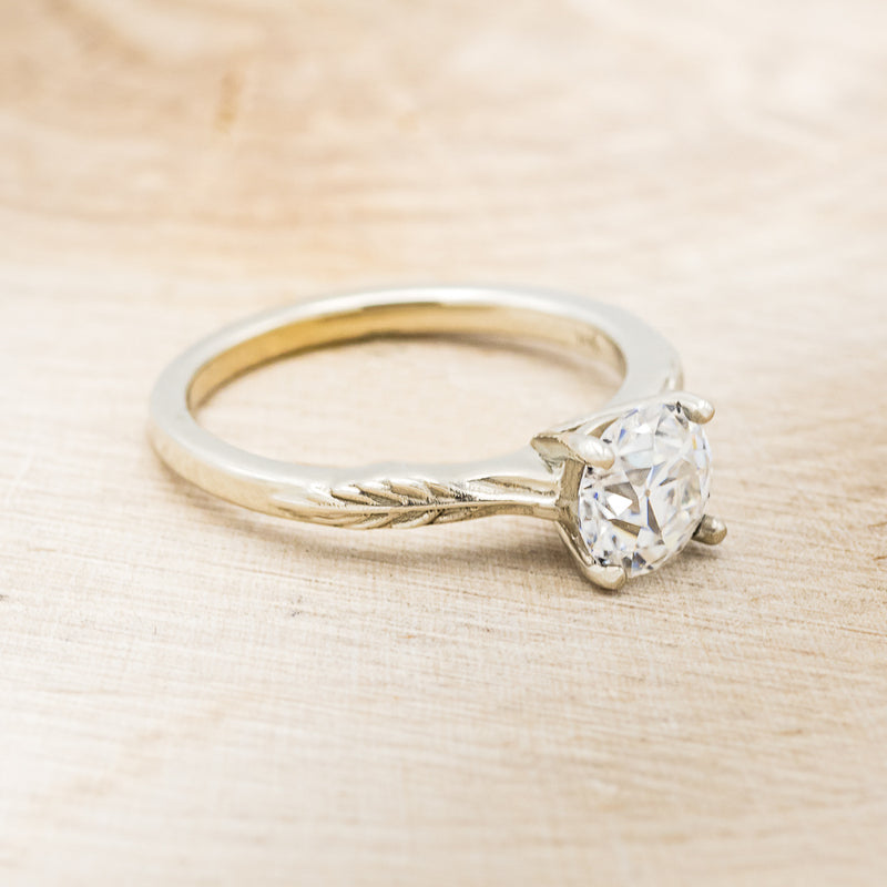 "HOPE" - ROUND CUT MOISSANITE SOLITAIRE ENGAGEMENT RING WITH FEATHER ACCENTS