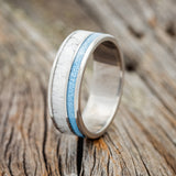 Shown here is "Raptor", a custom, handcrafted men's wedding ring featuring turquoise and antler inlays, upright facing left.