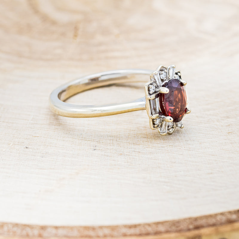 Shown here is "Cleopatra", an art deco-style oval garnet women's engagement ring with diamond accents, facing right. Many other center stone options are available upon request.