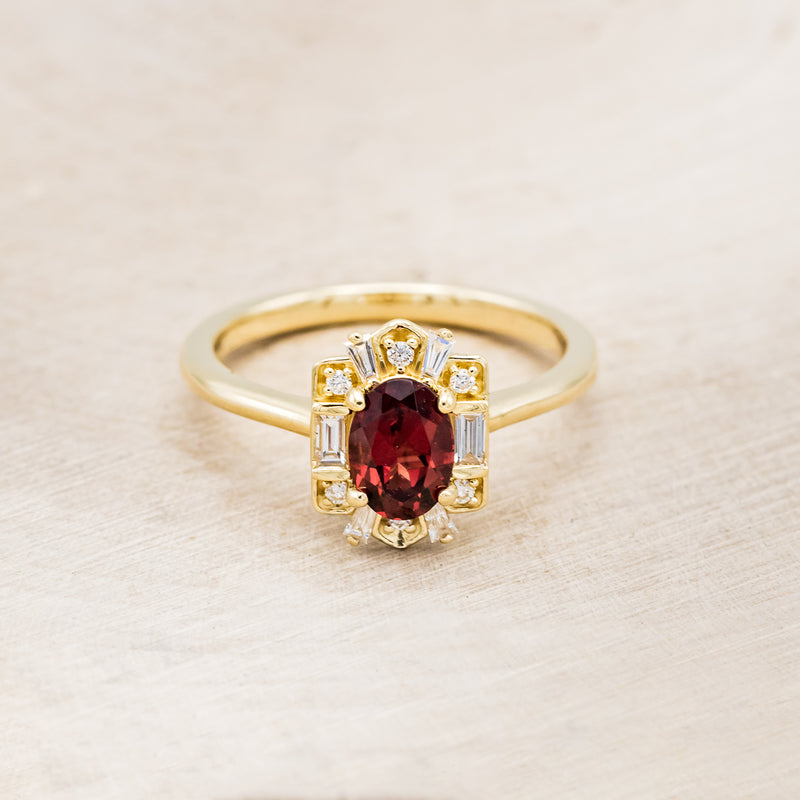 Shown here is "Cleopatra", an art deco-style oval garnet women's engagement ring with diamond accents, front facing. Many other center stone options are available upon request.