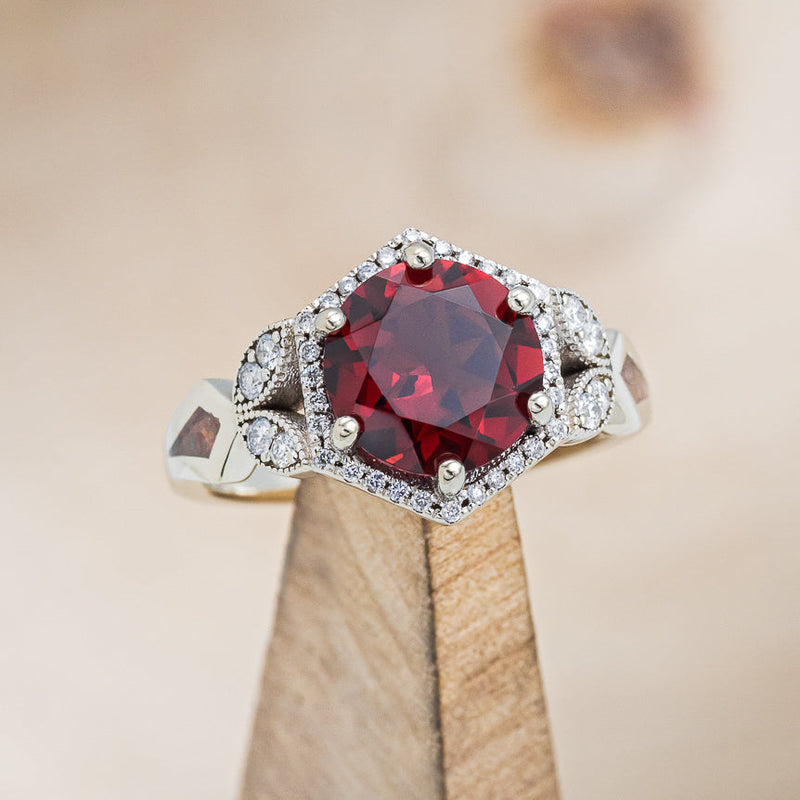 Shown here is The "Lucy in the Sky", a halo-style garnet women's engagement ring with diamond accents and red opal inlays. Many other center stone and inlay options are available upon request.
