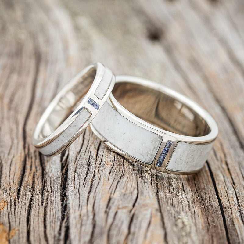 Shown here is a matching set of "Caspian" wedding rings featuring a naturally shed antler inlay and aquamarine stones on 14K gold bands, laying together. Additional inlay options are available upon request.