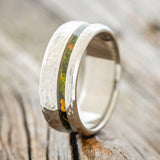 Shown here is "Vertigo",  a custom, handcrafted men's wedding ring featuring an offset mossy patina copper inlay with a hammered finish, shown facing right.  Additional inlay options are available upon request.