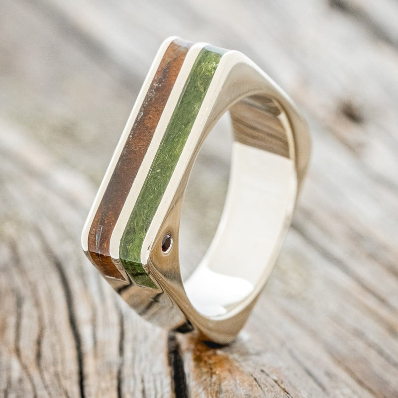 Shown here is "Vega",  a custom, handcrafted men's wedding band featuring moss and ironwood inlays with two offset rubies, design show facing right. Additional inlay options are available upon request.