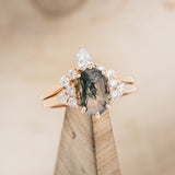 Shown here is "Octavia", a hexagon moss agate women's engagement ring with diamond accents and a diamond tracer, on stand front facing.  Many other center stone options are available upon request. 