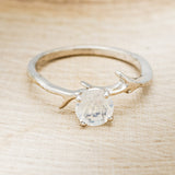 Shown here is "Artemis", an antler/branch-style round cut moonstone women's engagement ring, front facing. Many other center stone options are available upon request.