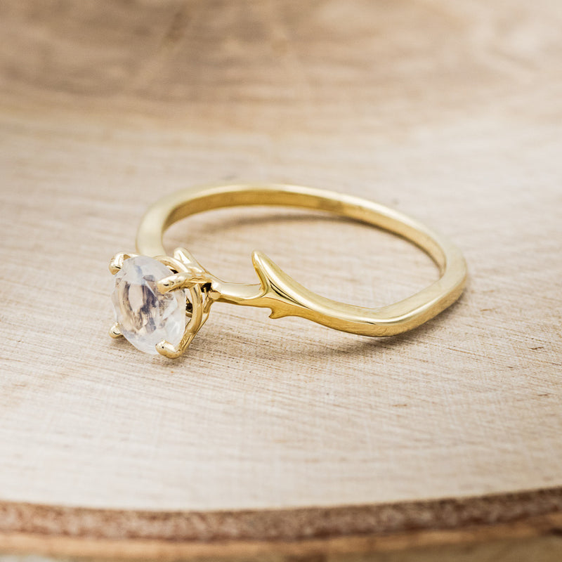 Shown here is "Artemis", an antler/branch-style round cut moonstone women's engagement ring, facing left. Many other center stone options are available upon request.