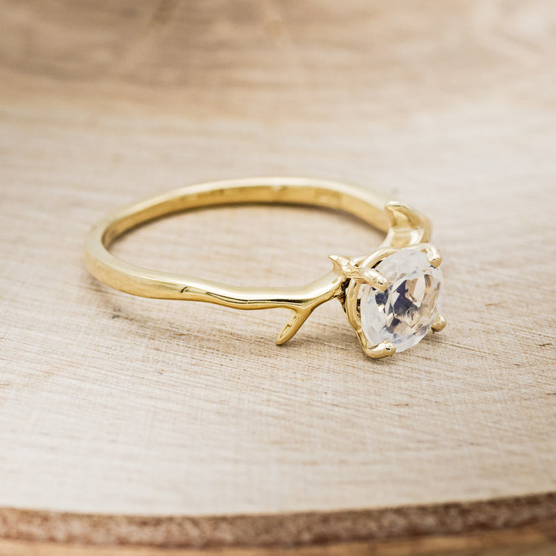 Shown here is "Artemis", an antler/branch-style round cut moonstone women's engagement ring, facing right. Many other center stone options are available upon request.