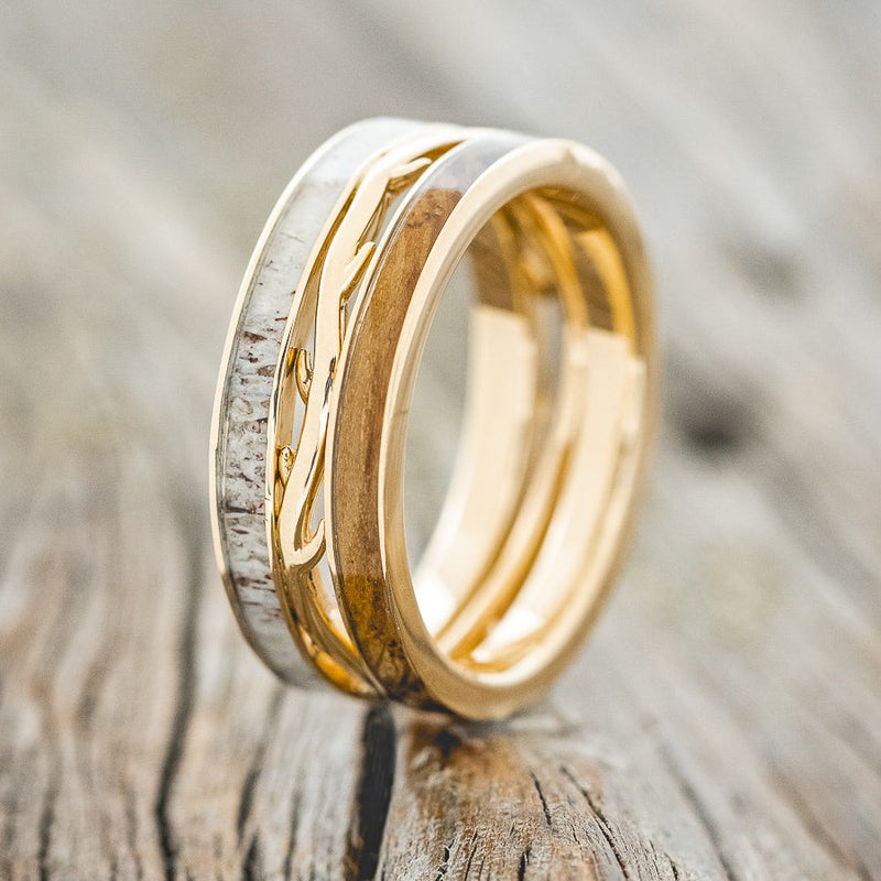 Shown here is men's "Artemis", a custom, handcrafted men's wedding ring featuring 2 channels with whiskey barrel oak and antler inlays, upright facing left. Additional inlay options are available upon request.