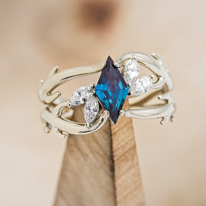 Shown here is "Artemis", an antler/branch-style lab-created alexandrite women's engagement ring with marquise diamond accents, on stand front facing. Many other center stone options are available upon request. 