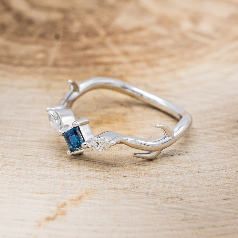 Shown here is "Artemis", an antler/branch-style lab-created alexandrite women's engagement ring with marquise diamond accents, facing left. Many other center stone options are available upon request.