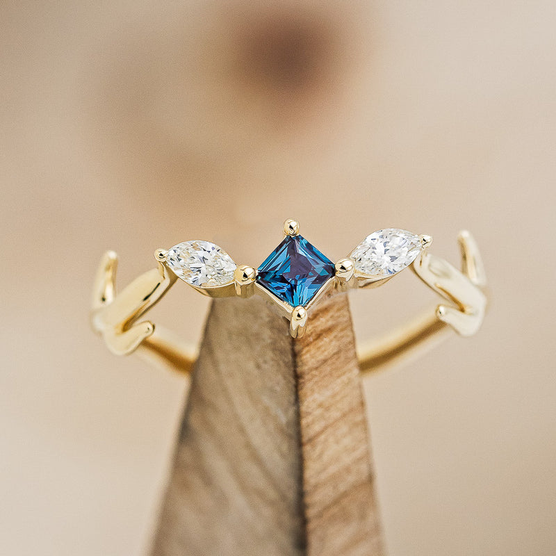 Shown here is "Artemis", an antler/branch-style lab-created alexandrite women's engagement ring with marquise diamond accents, on stand front facing. Many other center stone options are available upon request.