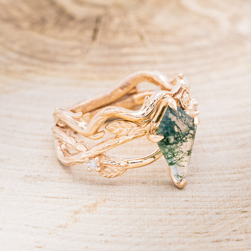 Shown here is "Artemis on the Vine", a branch-style moss agate women's engagement ring with diamonds, leaf accents and a floral tracer, facing right. Many other center stone options are available upon request.
