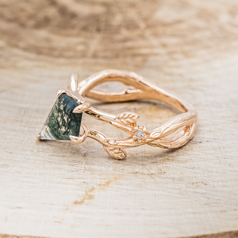 Shown here is "Artemis on the Vine", a branch-style moss agate women's engagement ring with diamond and leaf accents, facing left. Many other center stone options are available upon request.