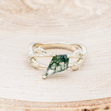 Shown here is "Artemis on the Vine", a branch-style moss agate women's engagement ring with diamond and leaf accents, front facing. Many other center stone options are available upon request.