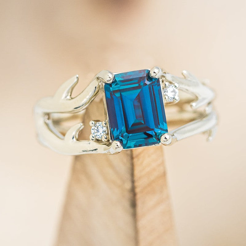 Shown here is "Artemis", an antler/branch-style lab-created alexandrite women's engagement ring with diamond accents, on stand front facing. Many other center stone options are available upon request. 