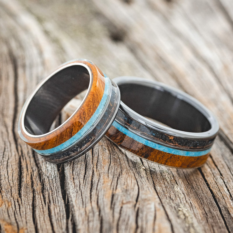 Shown here is a matching wedding band set featuring two "Element" rings with ironwood, patina copper, and turquoise on black zirconium bands, laying together. Additional inlay options are available upon request.