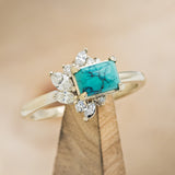 Shown here is "Aurae", an Art Deco-style turquoise women's engagement ring with diamond accents, upright facing left. Many other center stone options are available upon request.  