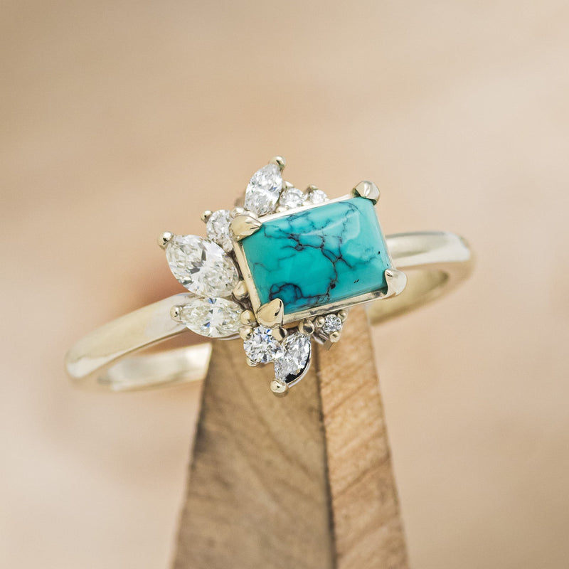 Shown here is "Aurae", an Art Deco-style turquoise women's engagement ring with diamond accents, upright facing left. Many other center stone options are available upon request.  