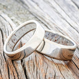 Shown here is a custom, handmade matching wedding band set featuring 2 antler lined bands. Additional lining options are available upon request.